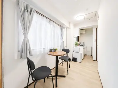 a small table and chairs in a room with a window at Shibuya, 3min walk Ebisu Sta, 2min Harajuku Sta,Queen bed in Tokyo
