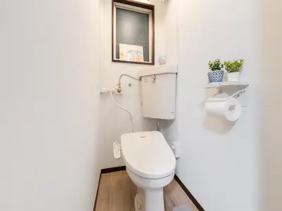 a small bathroom with a toilet and a window at Shibuya, 3min walk Ebisu Sta, 2min Harajuku Sta,Queen bed in Tokyo