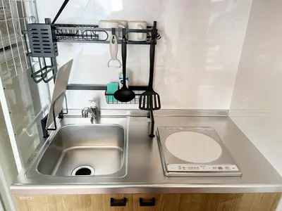 a small kitchen with a sink and a counter at jtr\u6d45\u8349\u6a4b401 in Tokyo
