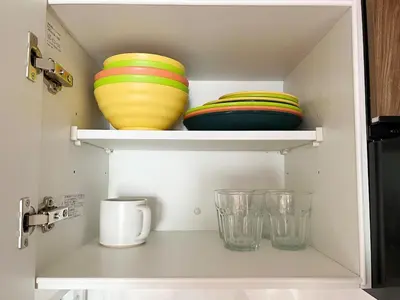 two bowls and glasses sitting on a shelf at jtr\u6d45\u8349\u6a4b401 in Tokyo