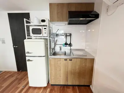 a small kitchen with a sink and a refrigerator at jtr\u6d45\u8349\u6a4b401 in Tokyo