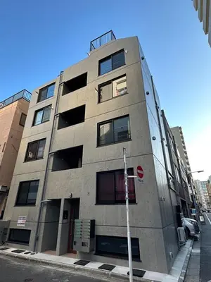 a building on the corner of a street at jtr\u6d45\u8349\u6a4b401 in Tokyo