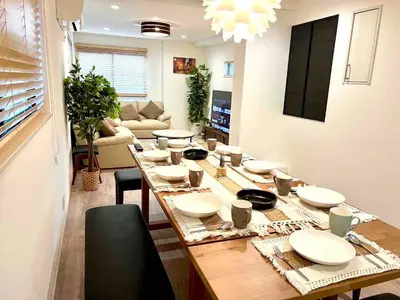a table with plates and bowls on it in a living room at \u843d\u5408\u30df\u30ea\u30aa\u30f3\u30cf\u30a6\u30b9 in Tokyo