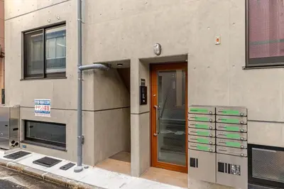 a building with a door and a sign on it at jtr\u6d45\u8349\u6a4b402 in Tokyo