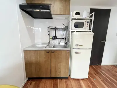 a small kitchen with a sink and a refrigerator at jtr\u6d45\u8349\u6a4b402 in Tokyo