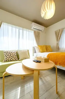 a room with a bed and a table and a couch at \u30af\u30ec\u30a2\u30fc\u30ec\u795e\u697d\u5742\u30b2\u30b9\u30c8\u30cf\u30a6\u30b9105\u53f7\u5ba4 - \u6771\u4eac\u89b3\u5149\u306b\u4fbf\u5229 - \u725b\u8fbc\u795e\u697d\u5742\u99c5\u304b\u3089\u5f92\u6b693\u5206 in Tokyo