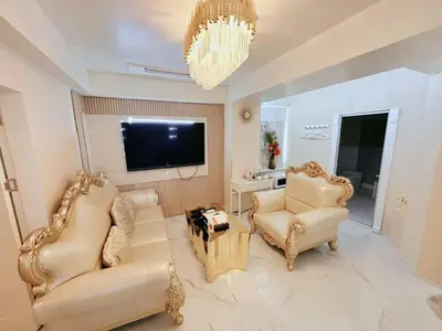 a living room with two chairs and a flat screen tv at Reimi Mondo703 in Tokyo