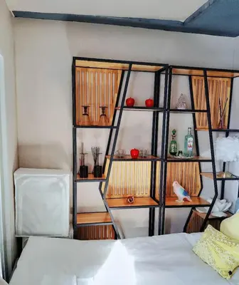a room with a book shelf next to a bed at Reimi Mondo703 in Tokyo