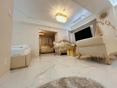 a large living room with a couch and a television at Reimi Mondo703 in Tokyo