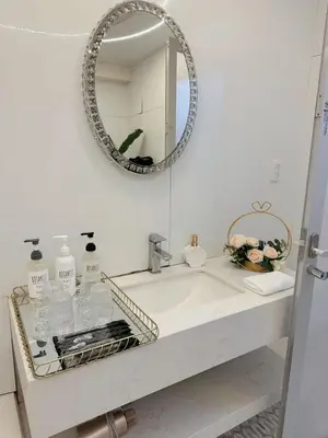 a bathroom with a sink and a mirror at Reimi Mondo703 in Tokyo