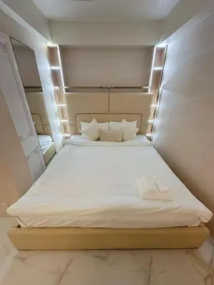 a large white bed with two slippers on it at Reimi Mondo703 in Tokyo