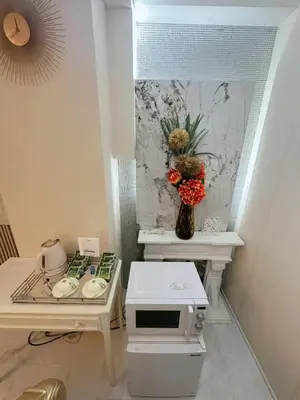 a small kitchen with a table and a microwave at Reimi Mondo703 in Tokyo