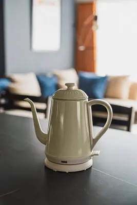 a white tea kettle sitting on a table at Luxury Stay near Azabudai Hills and Tokyo Tower, 2-Bedroom Apartment in Tokyo