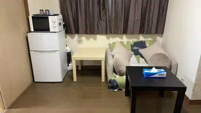 a small living room with a couch and a table at 21\u89c2\u666f\u9633\u53f0\u623f \u5927\u7a7a\u95f4\u536b\u6d74\u53a8\u623f \u6d17\u8863\u673a \u8f66\u7ad9\u6b65\u884c3\u5206\u949f \u4e0a\u91ce \u6d89\u8c37 \u8fea\u58eb\u5c3c \u673a\u573a \u5750\u8f66\u76f4\u8fbe in Tokyo