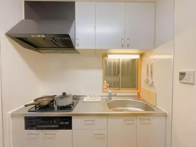 a kitchen with a sink and a stove top oven at \u53cb\u7e01\u306e\u5bb6Destined Bonds Haven\u5317\u5343\u4f4f in Tokyo