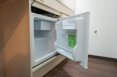 an empty refrigerator with its door open in a room at \u738b202\u6574\u5957\u79c1\u4eba\u536b\u6d74\u53a8\u623f \u6d17\u8863\u673a \u8f66\u7ad9\u6b65\u884c5\u5206\u949f \u4e0a\u91ce\u7ad9\u5730\u94c1\u76f4\u8fbe in Tokyo