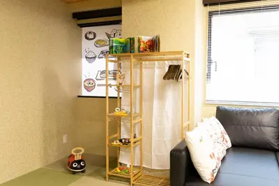 a living room with a couch and a shelf at SLEEPLAB \u795e\u697d\u5742 -Kagurazaka- in Tokyo