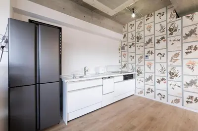 a kitchen with white cabinets and a refrigerator at SLEEPLAB \u795e\u697d\u5742 -Kagurazaka- in Tokyo