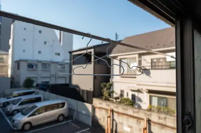 a view from a window of a parking lot with cars at \u738b102\u6574\u5957\u79c1\u4eba\u536b\u6d74\u53a8\u623f \u6d17\u8863\u673a \u8f66\u7ad9\u6b65\u884c5\u5206\u949f \u4e0a\u91ce\u7ad9\u5730\u94c1\u76f4\u8fbe in Tokyo