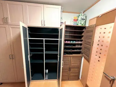 a walk in closet with lots of shoes at \u8cb4\u9802\u5e9c\u90b8 \u95a2\u539f KICYO HOUSE No3 in Tokyo