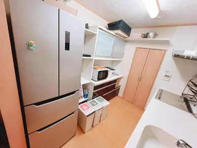 a small kitchen with a refrigerator and a sink at \u8cb4\u9802\u5e9c\u90b8 \u95a2\u539f KICYO HOUSE No3 in Tokyo