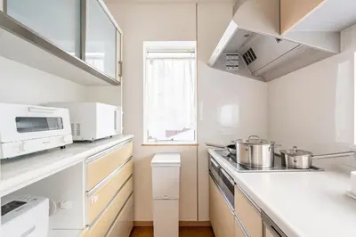 a kitchen with two pots and a microwave at hotel fleur-3F in Tokyo