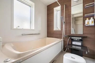 a bathroom with a tub and a toilet and a window at hotel fleur-3F in Tokyo