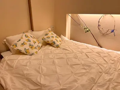 a white bed with two pillows on top of it at hotel fleur-3F in Tokyo