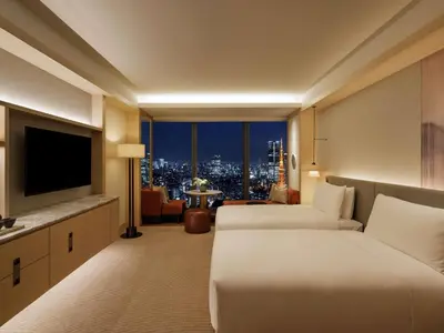 a hotel room with two beds and a television at Fairmont Tokyo in Tokyo