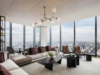 a living room with a couch and chairs and windows at Fairmont Tokyo in Tokyo
