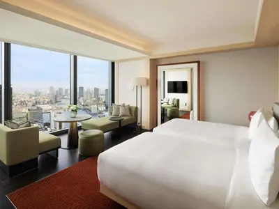 a hotel room with a large bed and a large window at Fairmont Tokyo in Tokyo