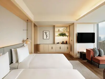 a hotel room with a bed and a flat screen tv at Fairmont Tokyo in Tokyo