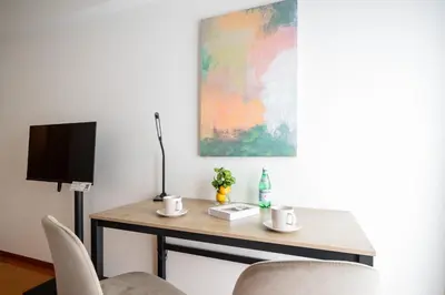 a table with two cups and a tv on it at \u30a2\u30eb\u30ab\u30c7\u30a3\u30a2\u897f\u84b2\u7530 in Tokyo