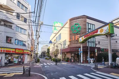 a city street with buildings and a crosswalk at \u30a2\u30eb\u30ab\u30c7\u30a3\u30a2\u897f\u84b2\u7530 in Tokyo