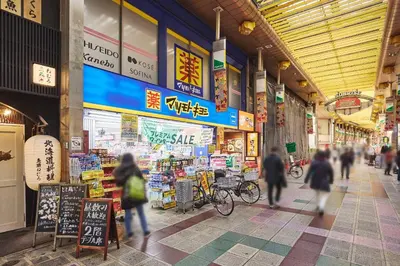 a group of people walking through a shopping mall at \u30a2\u30eb\u30ab\u30c7\u30a3\u30a2\u897f\u84b2\u7530 in Tokyo