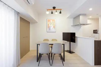 a dining room with a table and two chairs at \u30ec\u30fc\u30f4\u6d45\u8349 in Tokyo