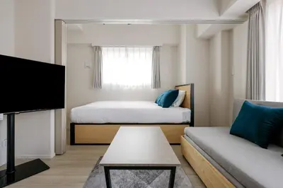 a small room with a bed and a couch at \u30ec\u30fc\u30f4\u6d45\u8349 in Tokyo