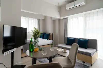 a living room with a couch and a table at \u30ec\u30fc\u30f4\u6d45\u8349 in Tokyo