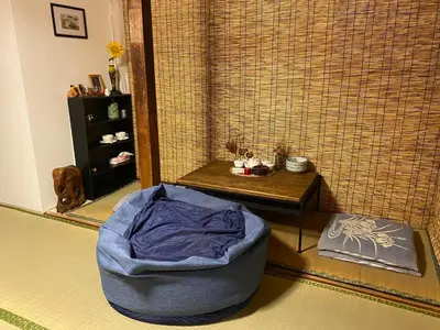 a room with a blue dog bed and a table at \u4ec1\u6e90\u548c in Tokyo