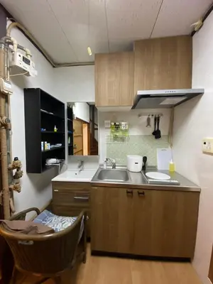 a kitchen with wooden cabinets and a sink at \u4ec1\u6e90\u548c in Tokyo