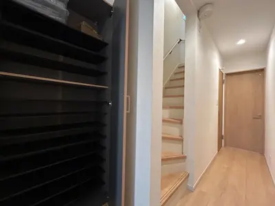 a walk in closet with black shelving and stairs at jtr\u58a8\u75303\u4e01\u76ee in Tokyo