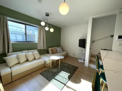 a living room with a white couch and a tv at jtr\u58a8\u75303\u4e01\u76ee in Tokyo
