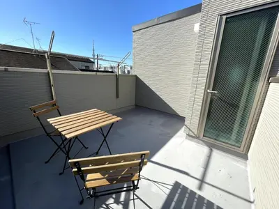 a wooden table and chair sitting on a balcony at jtr\u58a8\u75303\u4e01\u76ee in Tokyo