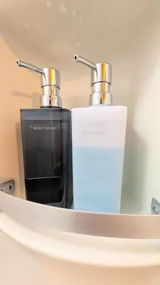 a mirror with two complimentary bottles of soap at Joe Backpackers in Tokyo