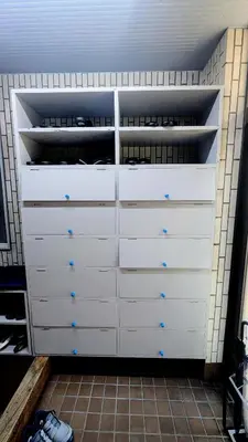 a closet with white drawers in a room at Joe Backpackers in Tokyo