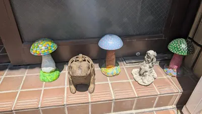 a group of miniature mushrooms on a tile floor at Joe Backpackers in Tokyo