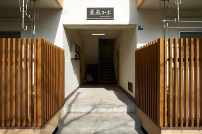 a hallway of a building with a gate and stairs at \u30d5\u30b8\u30bf\u30ad\u30b3\u30fc\u30dd in Tokyo