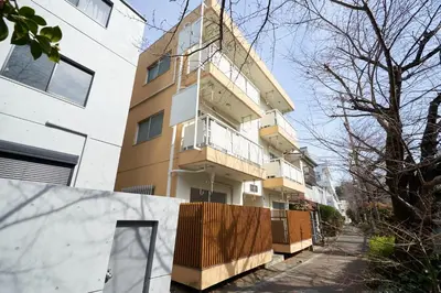 an apartment building with a fence in front of it at \u30d5\u30b8\u30bf\u30ad\u30b3\u30fc\u30dd in Tokyo