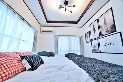 a bedroom with a large bed with pillows on it at Direct Shinjuku Max 10 Tokyo Hostel Shinozaki in Tokyo