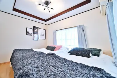 a bedroom with two beds and a window at Direct Shinjuku Max 10 Tokyo Hostel Shinozaki in Tokyo